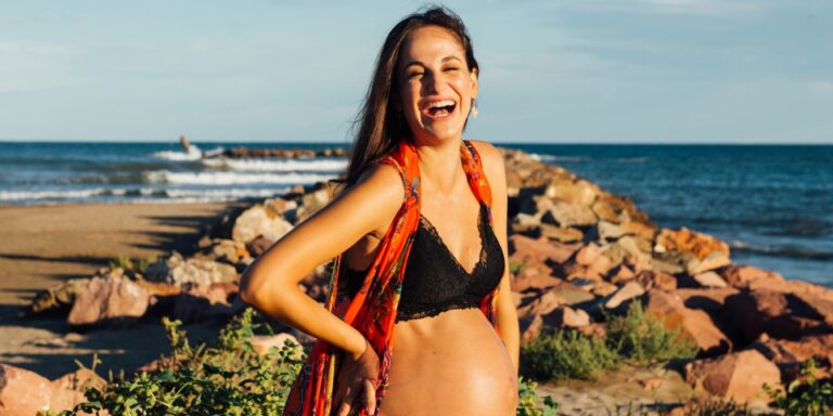 happy pregnant woman at the beach