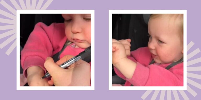 mom writing on toddlers hand